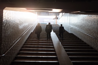 three man walking on stair