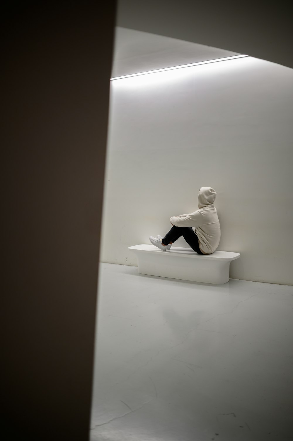 man sitting on white floor