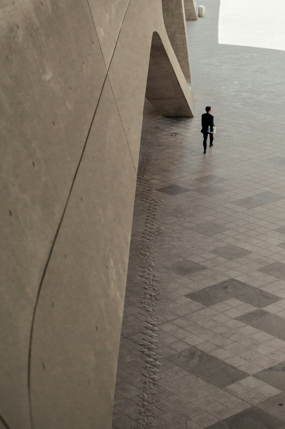 man walking beside building