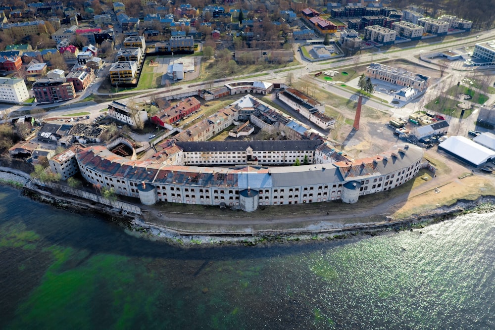 aerial photography of gray concrete building near body of water