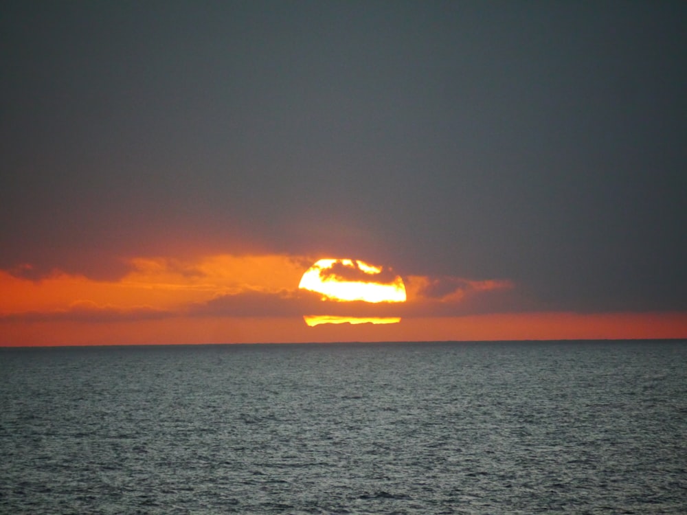 sun above body of water