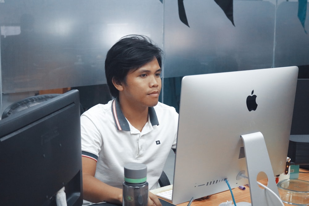 man in front of iMac