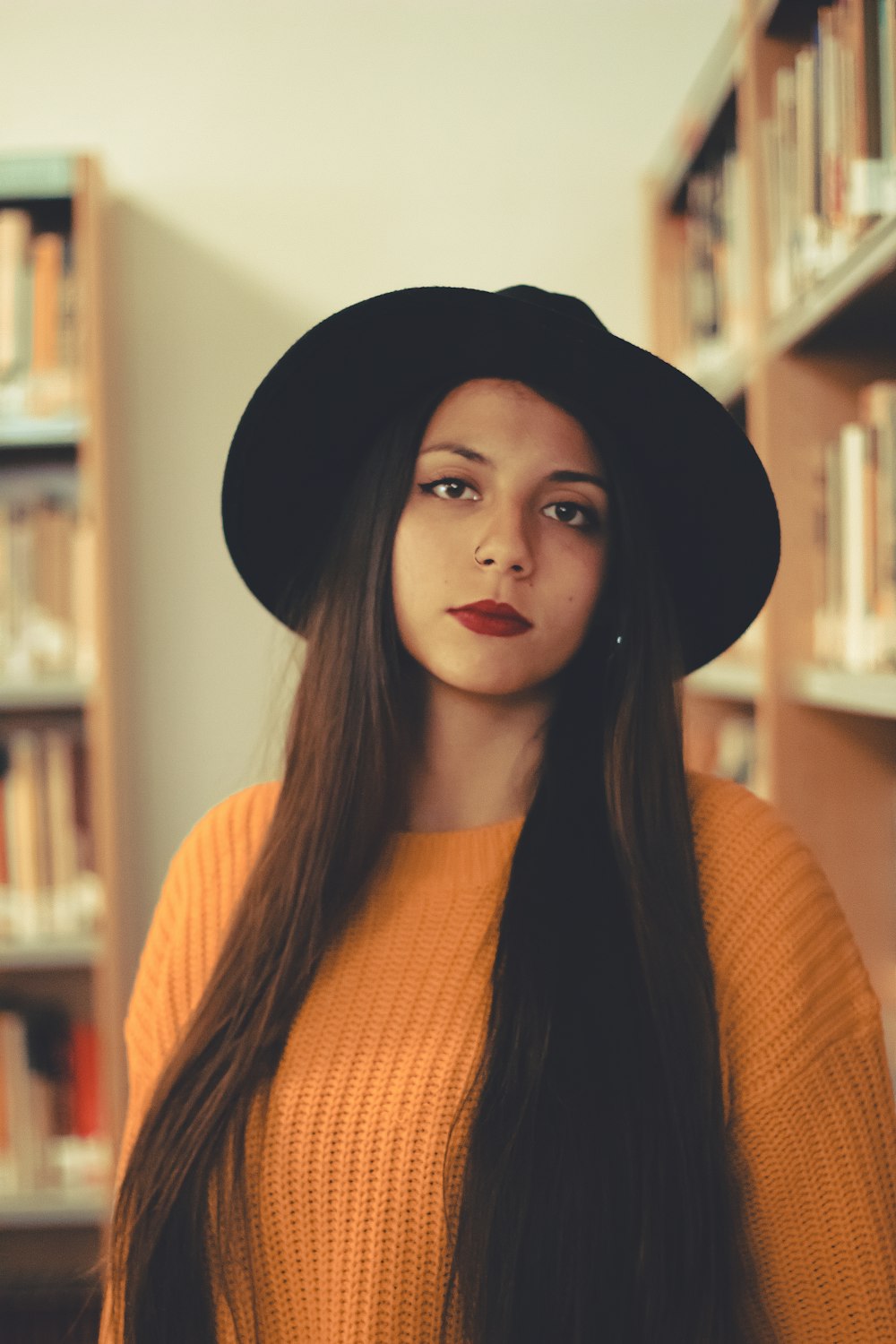 woman standing wearing black hat