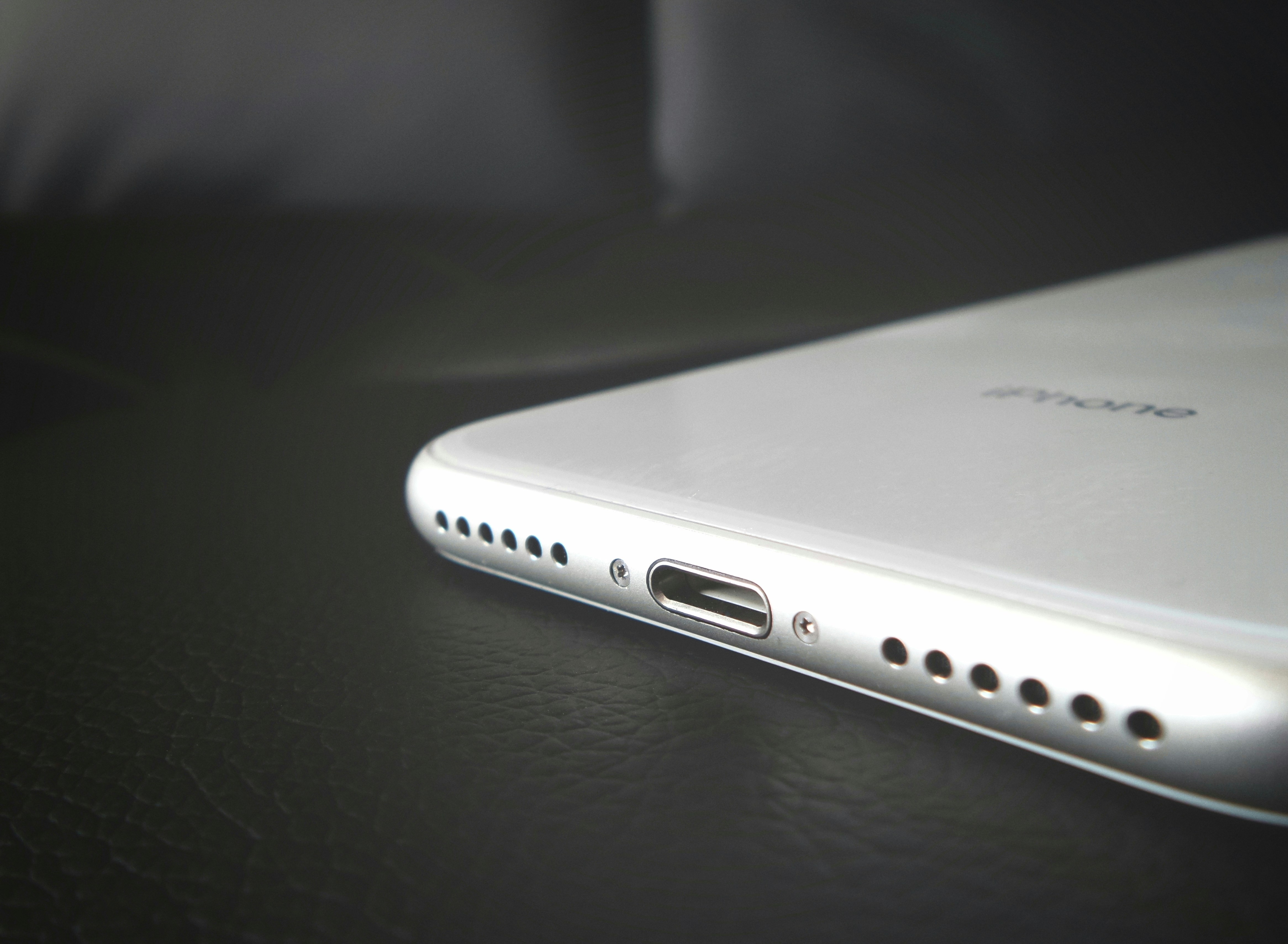 iPhone lightning charging port flex assembly on dark surface