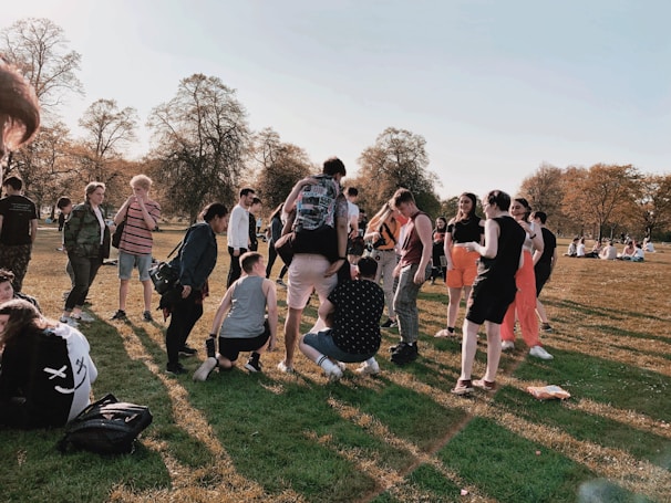 A group enjoying a community outing, smiling and engaging in an accessible park setting.