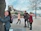 Group of friends joyfully exploring a vibrant cityscape with digital map overlays.