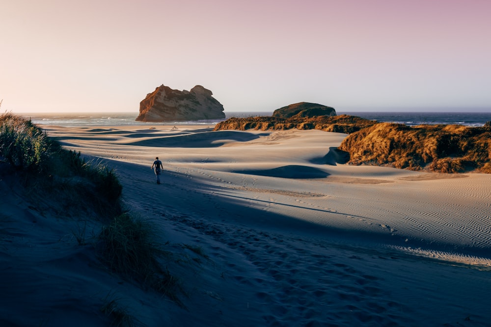 man walking on the sand