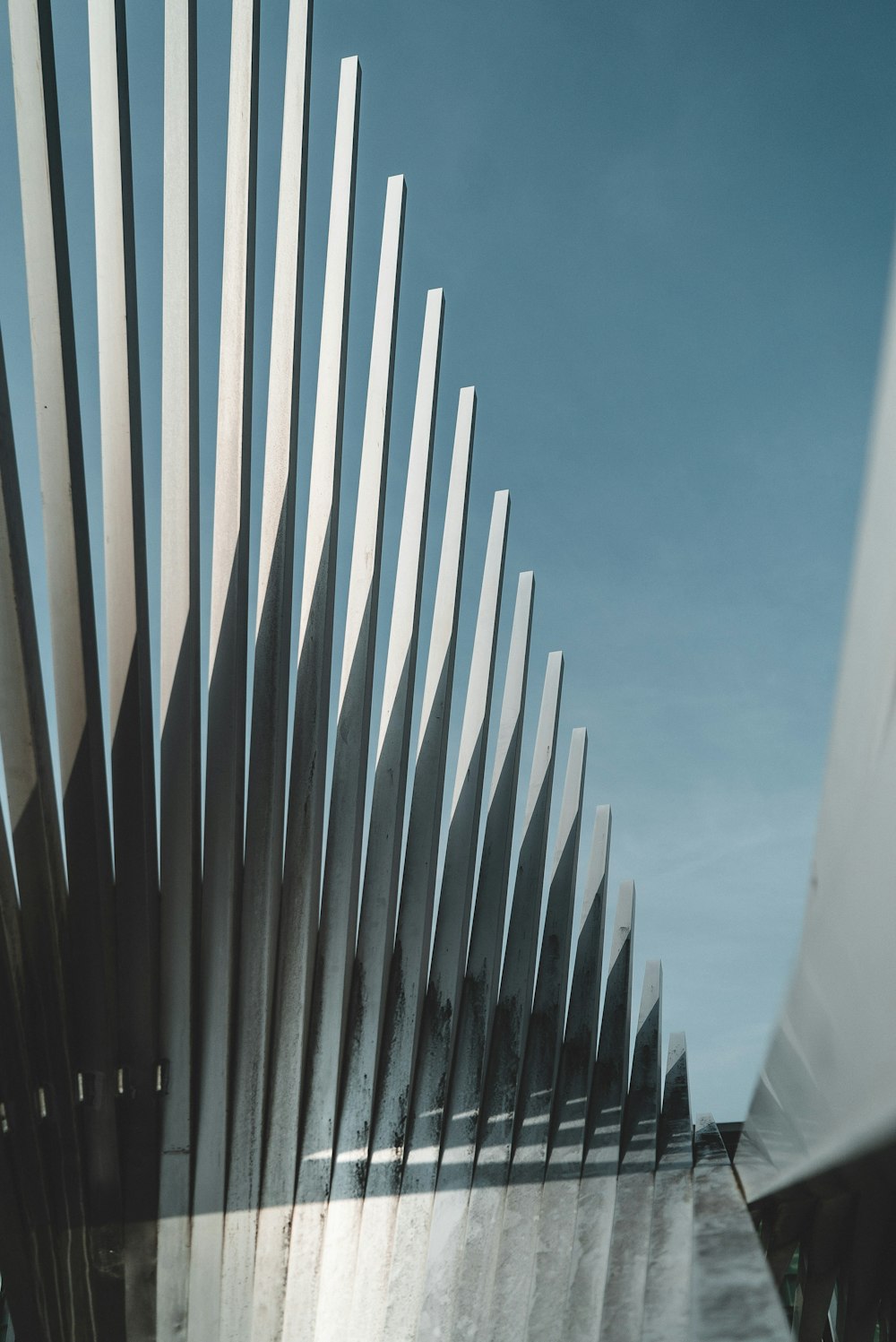 a close up of a metal structure with a sky background