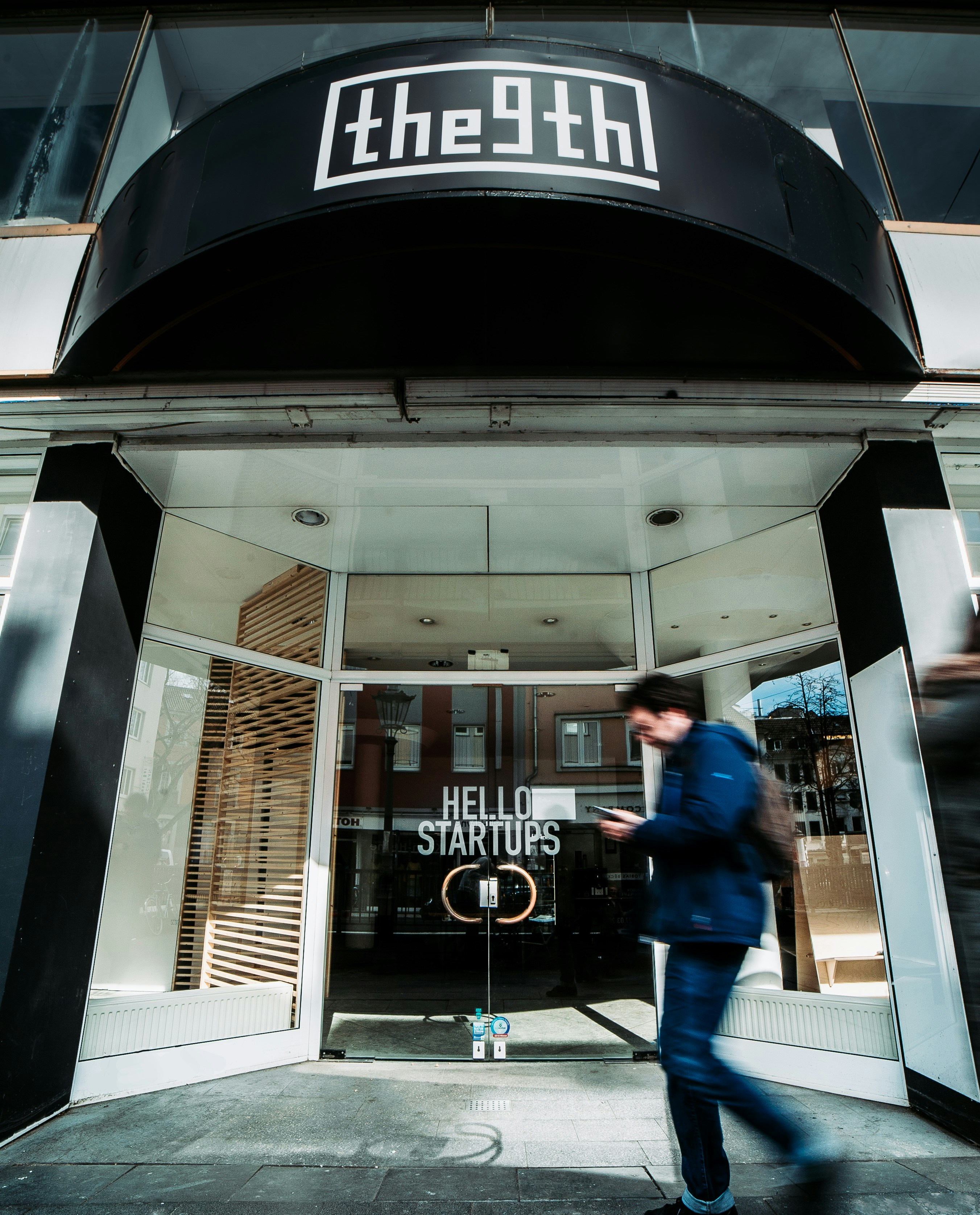 Man Walking Outside The 9th Building Photo Free Human