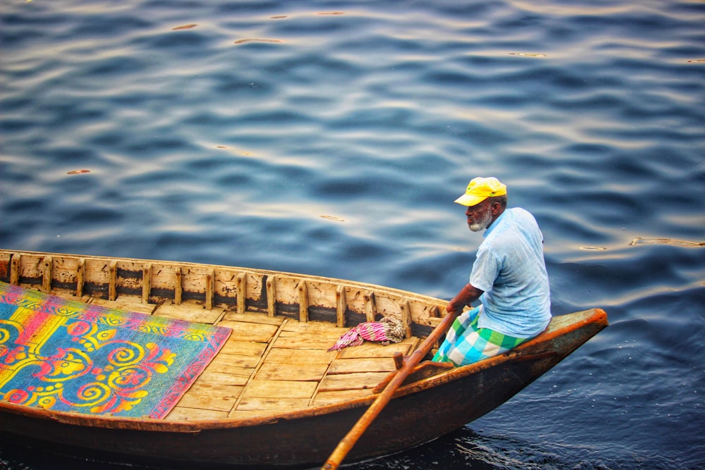 man riding boat during daytime