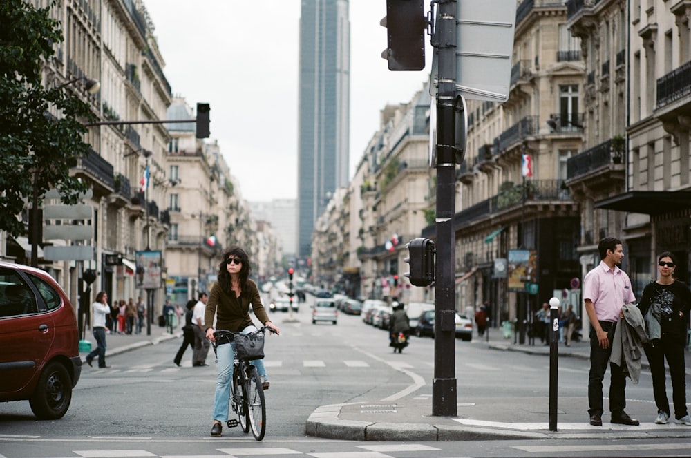 people walking and biking on street near buildings