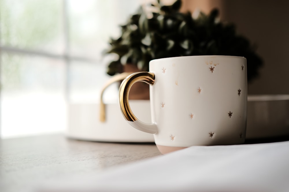 white ceramic mug on gray surface