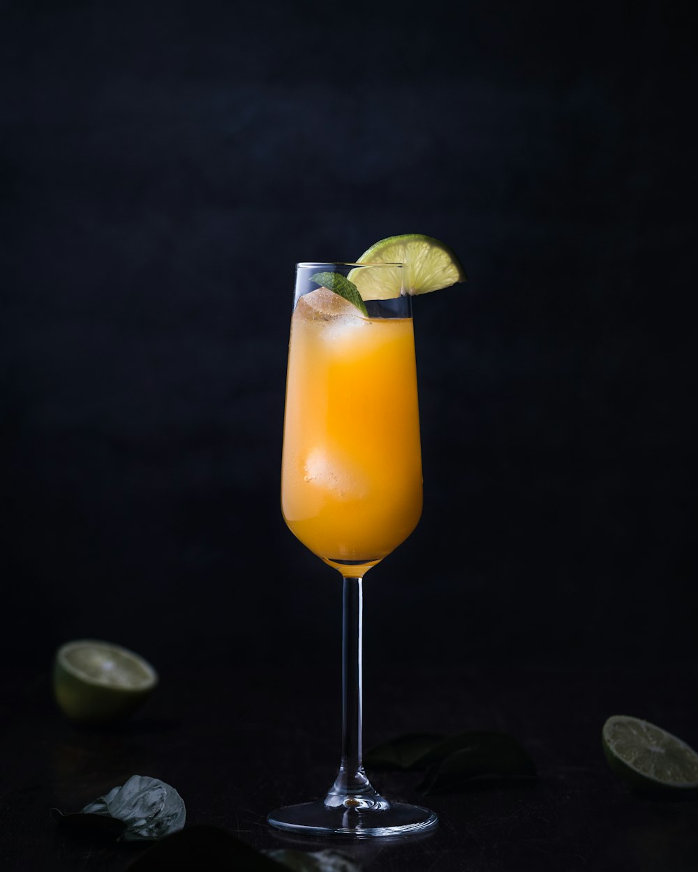 orange juice on clear glass