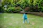 A happy child running on a playground wearing bright colorful running shoes.
