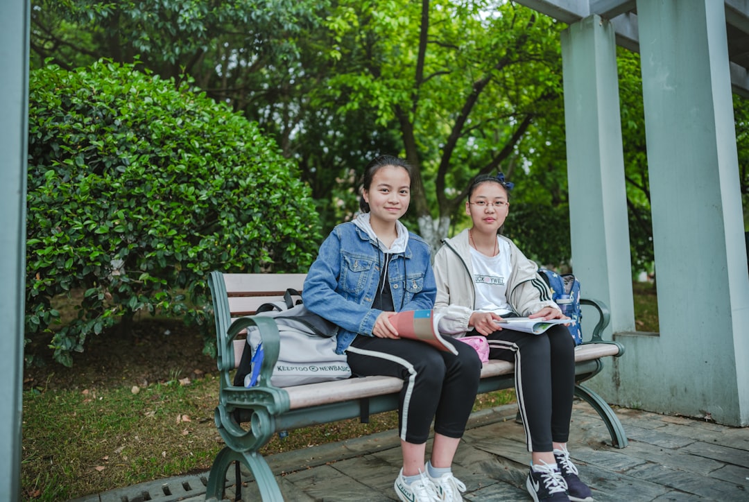 two girls sitting on bench