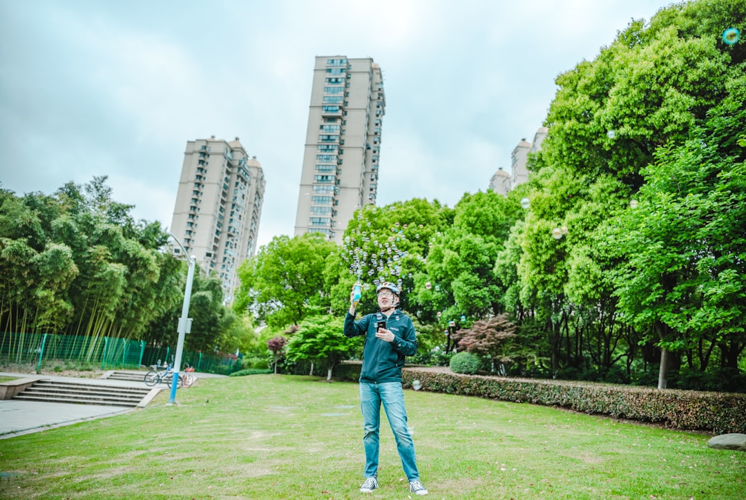 man standing on grass near trees