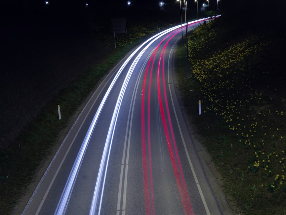 a long exposure photo of a highway at night