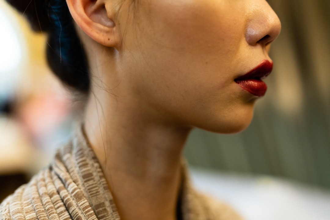 selective focus photography of woman in red lipstick