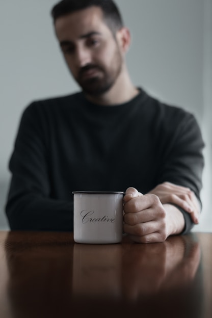 man sitting holding mug