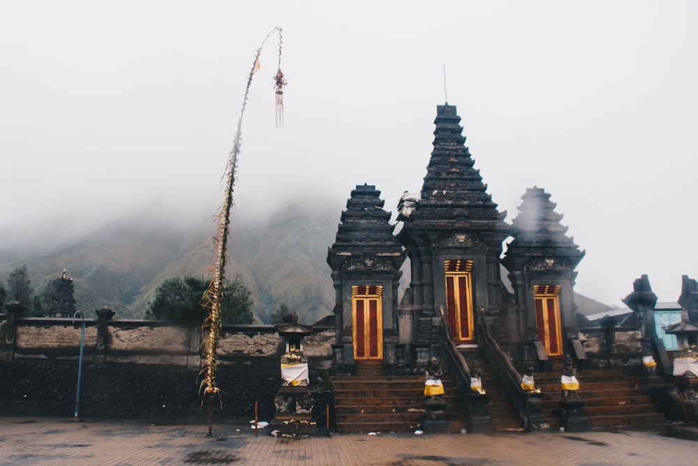 gray concrete shrine on foggy daytime