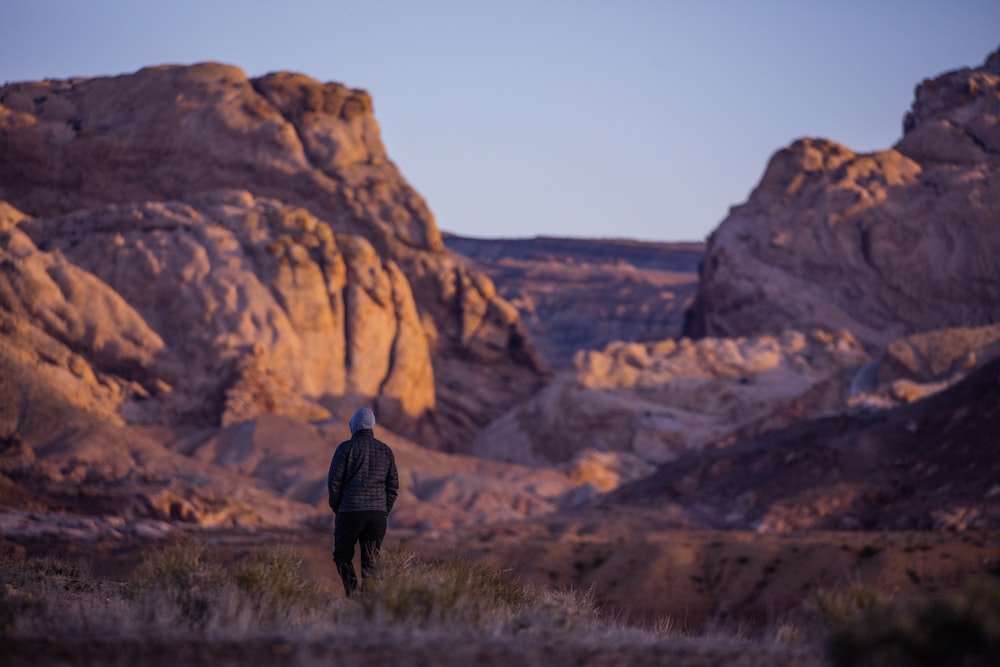 person walking near rock formation