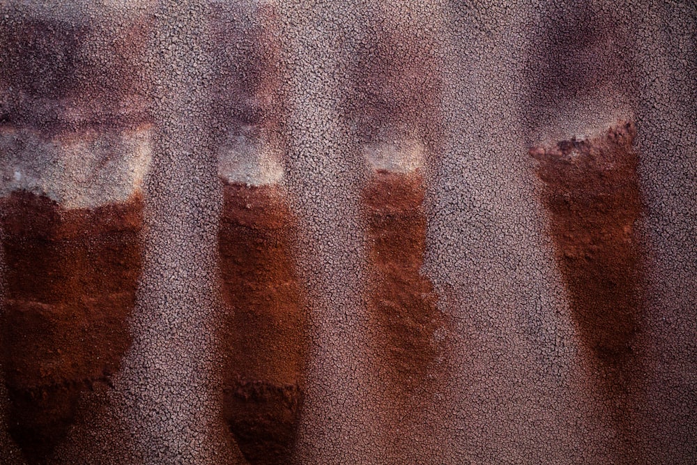 a close up of a person's feet with brown and white paint on them
