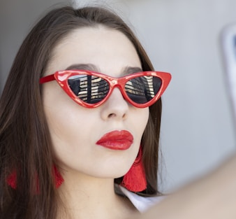 woman wearing classic red framed sunglasses