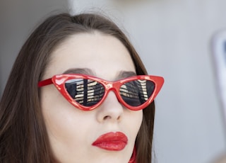 woman wearing classic red framed sunglasses