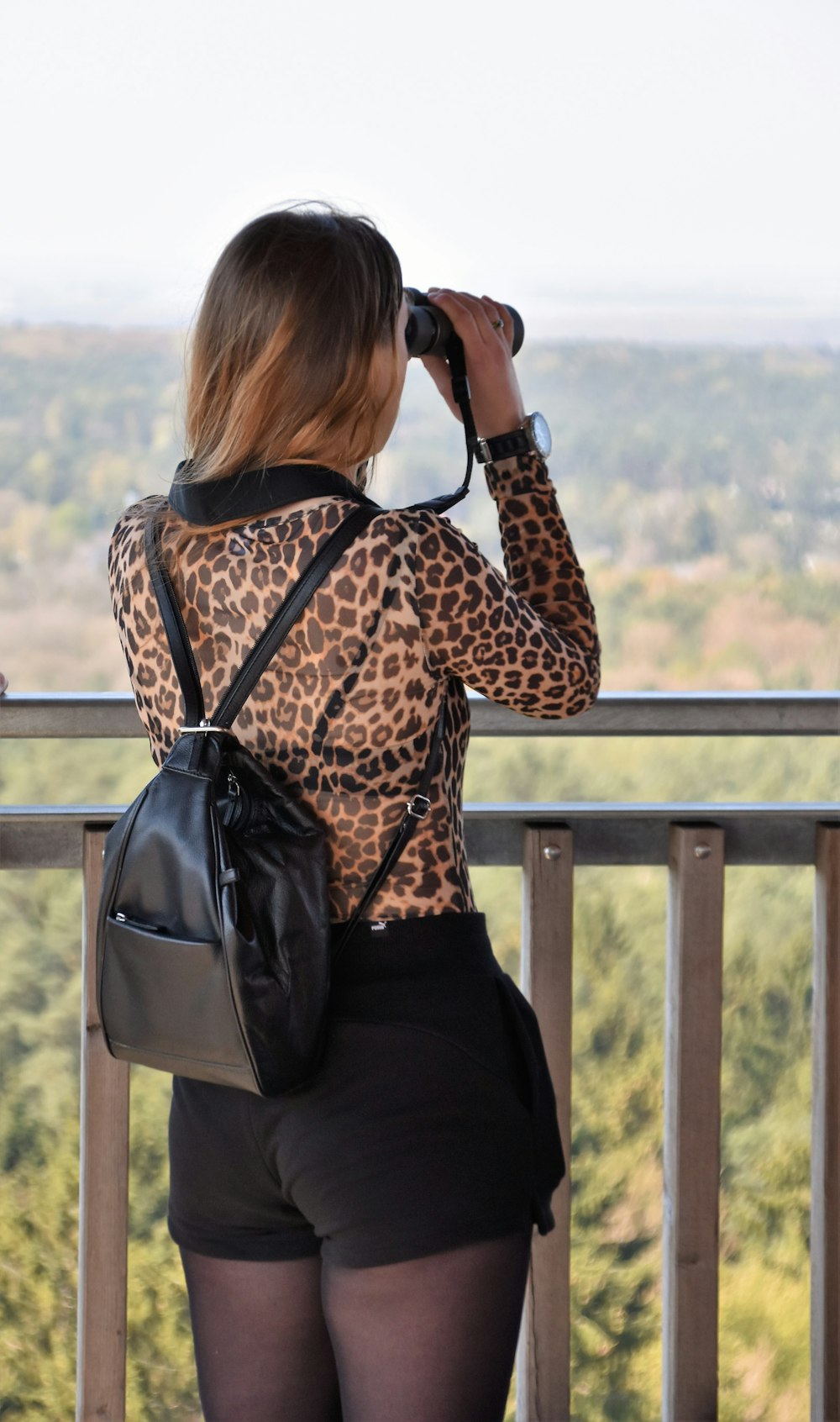 woman looking on binoculars