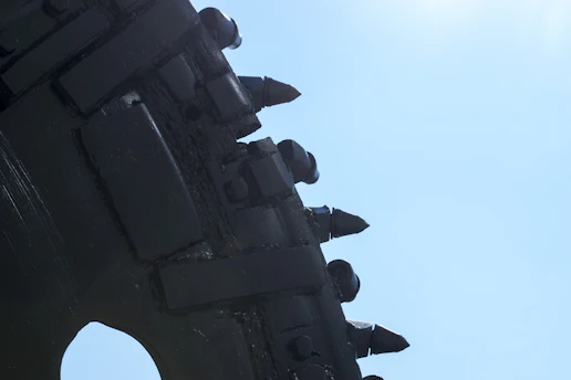 Close-up of advanced drilling equipment set against a deep blue industrial backdrop.
