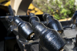 Close-up of a high chrome blow bar mounted on a heavy-duty impact crusher in a mining site.
