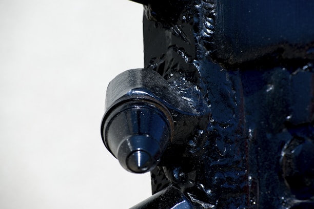 A close-up of a laser surface scanner capturing detailed textures on a small mechanical part.