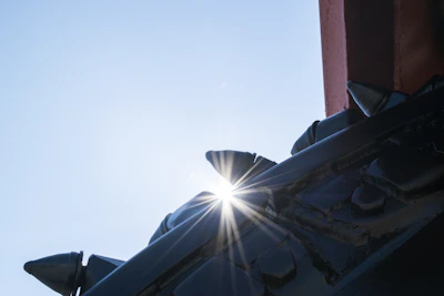 A close-up of a metal geometric ornament catching the sunlight.