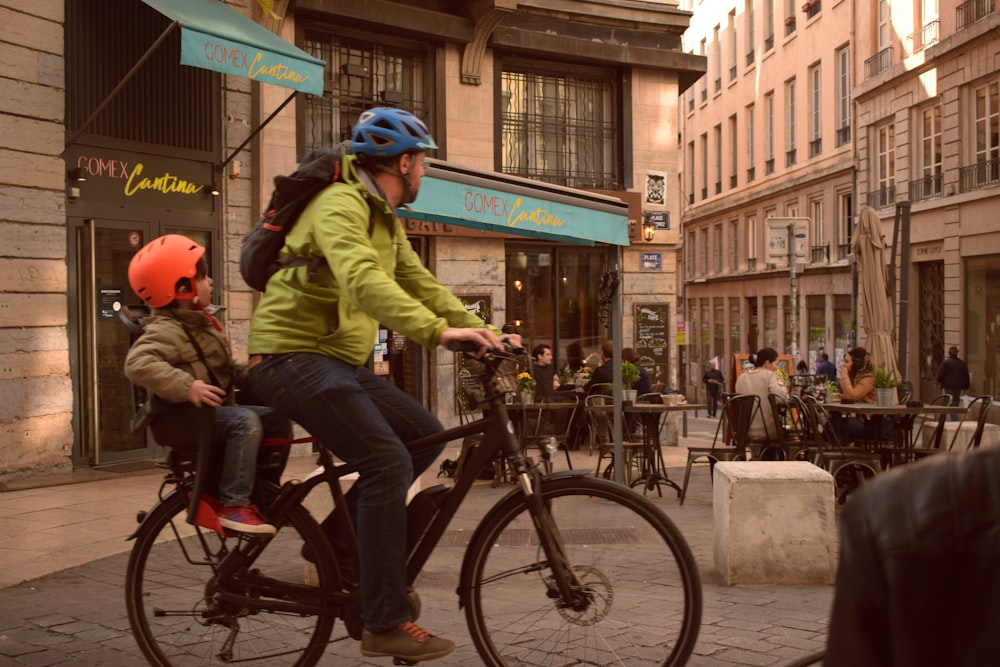 man in green jacket riding bicycle
