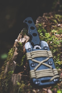 black and gray knife on wooden surface