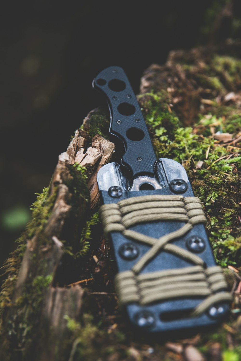 black and gray knife on wooden surface