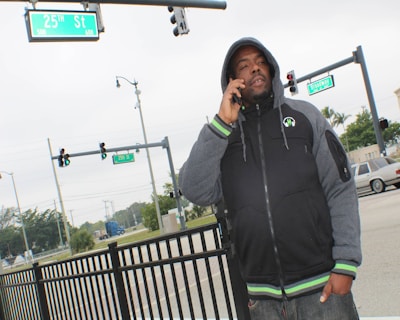 A credible messenger speaking with local youth on a city street corner.