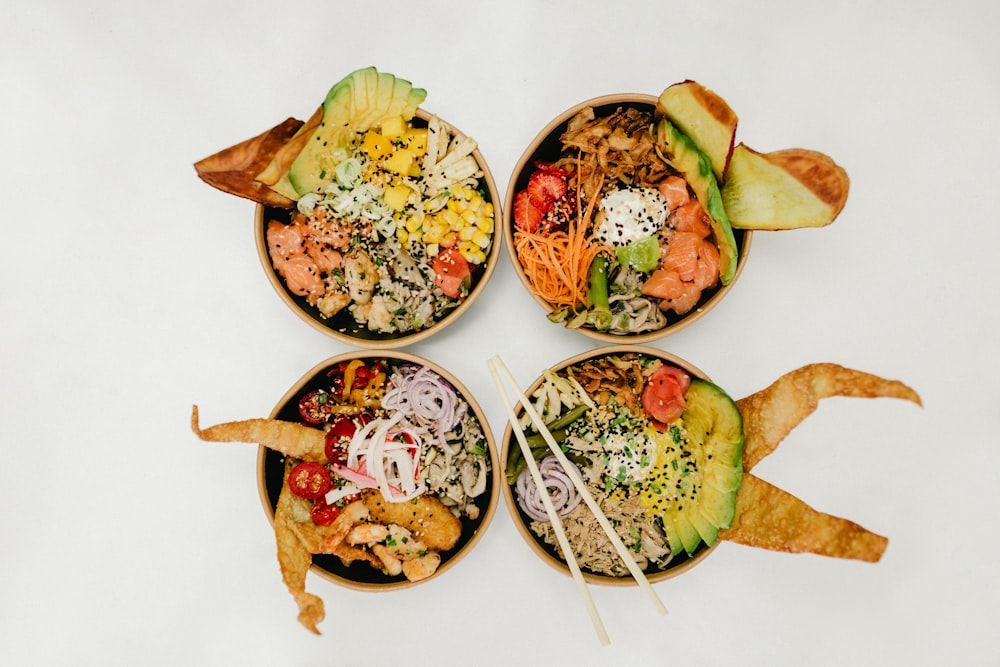 assorted cooked foods in four bowls