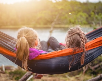 two women lying on hammock