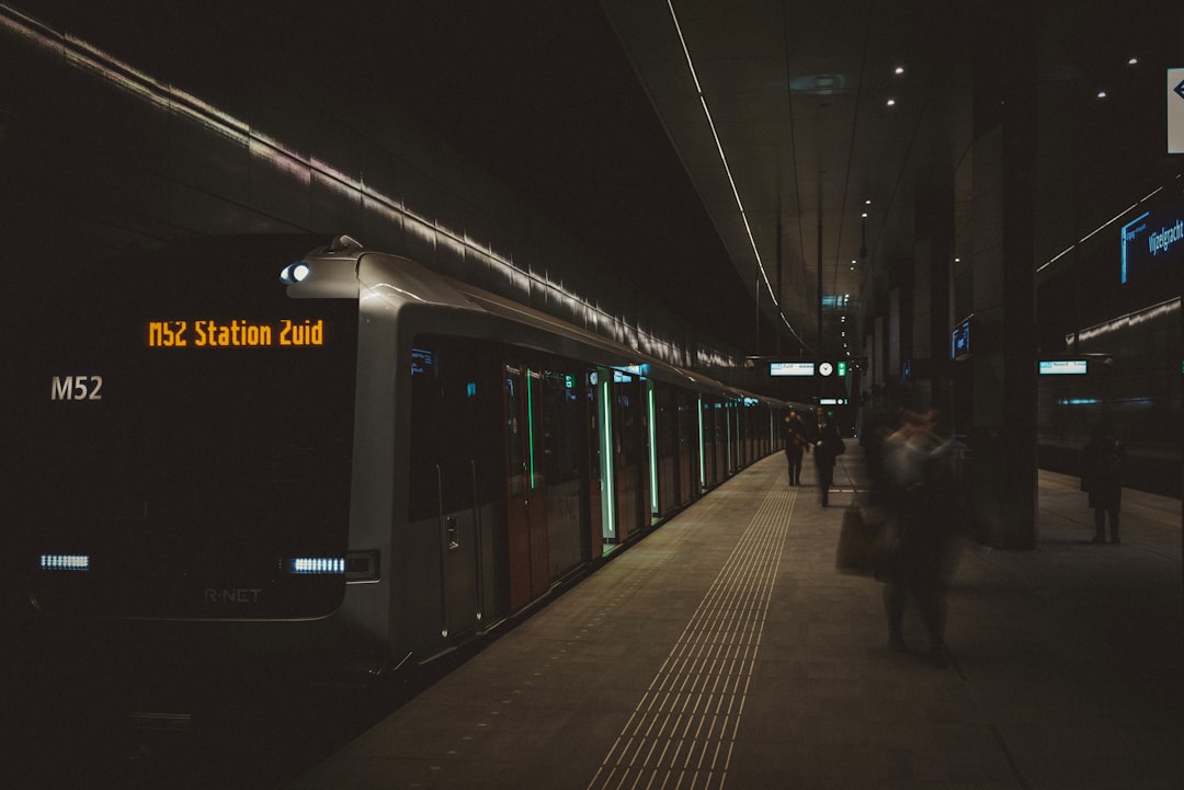 people standing beside train displaying M52 Station