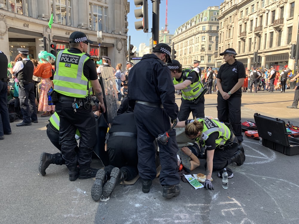 people rescuing man lying on ground