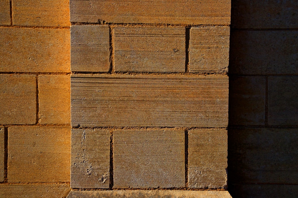 a red fire hydrant sitting next to a brick wall