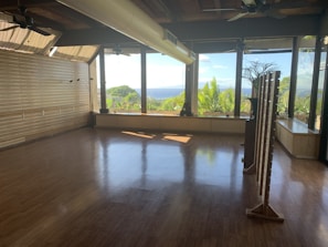 A spacious room with large windows offering a beautiful view.