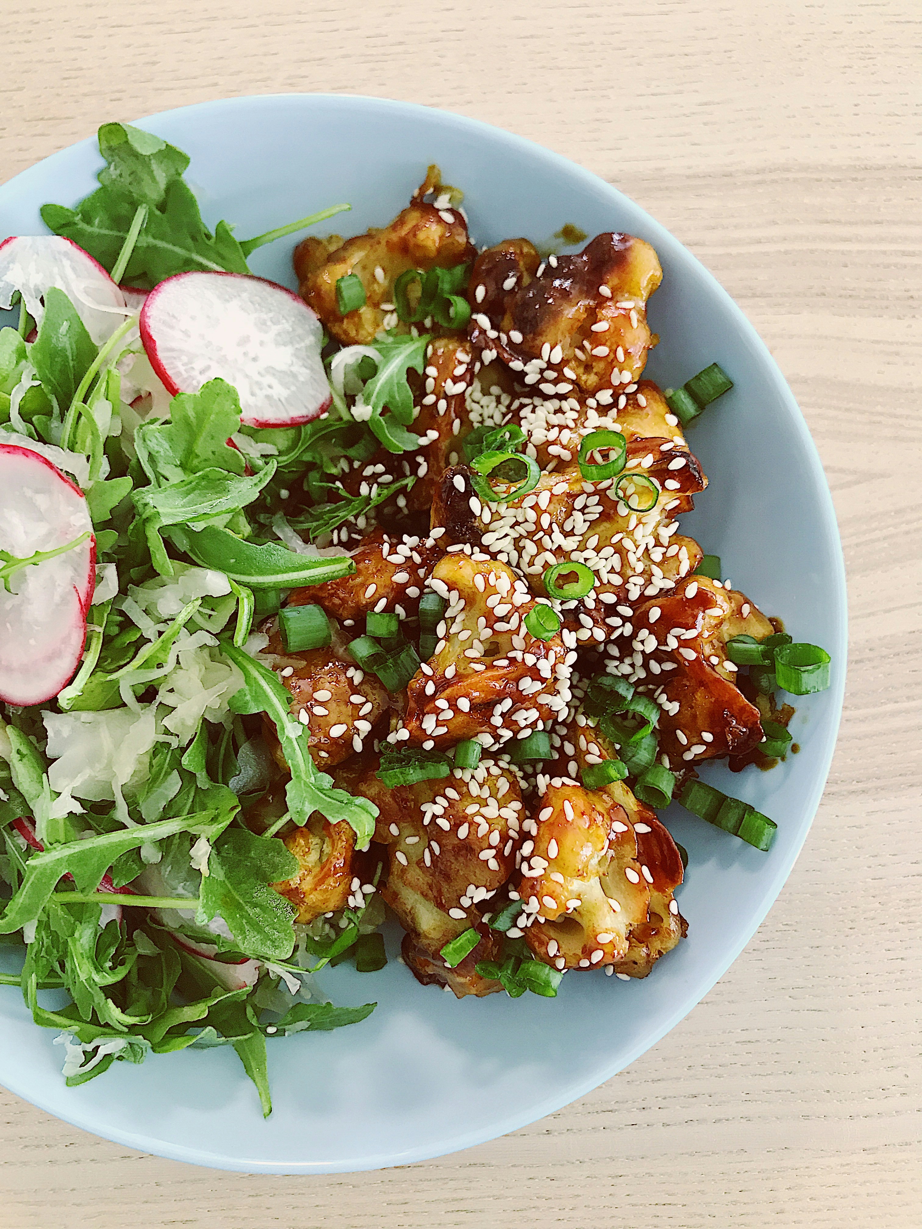 Classic crispy fried chicken pieces with golden coating on a wooden board, warm studio lighting