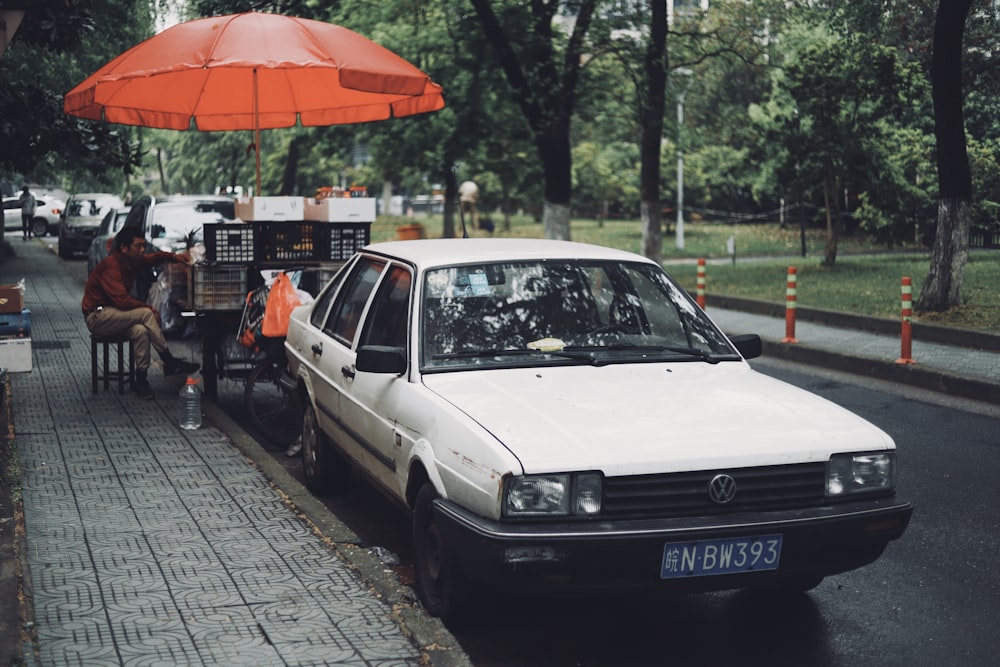 white Volkswagen sedan on park