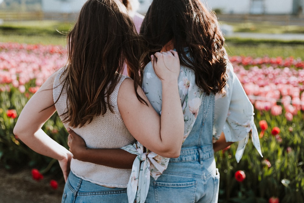 two women in front of flowers