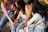 An intimate shot of women sitting in a circle, sharing stories and laughter outdoors.