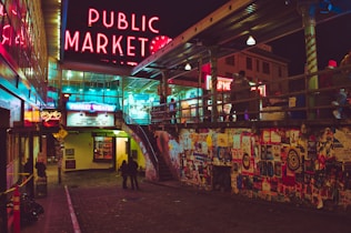 a public market with neon signs and people