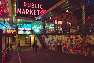 a public market with neon signs and people