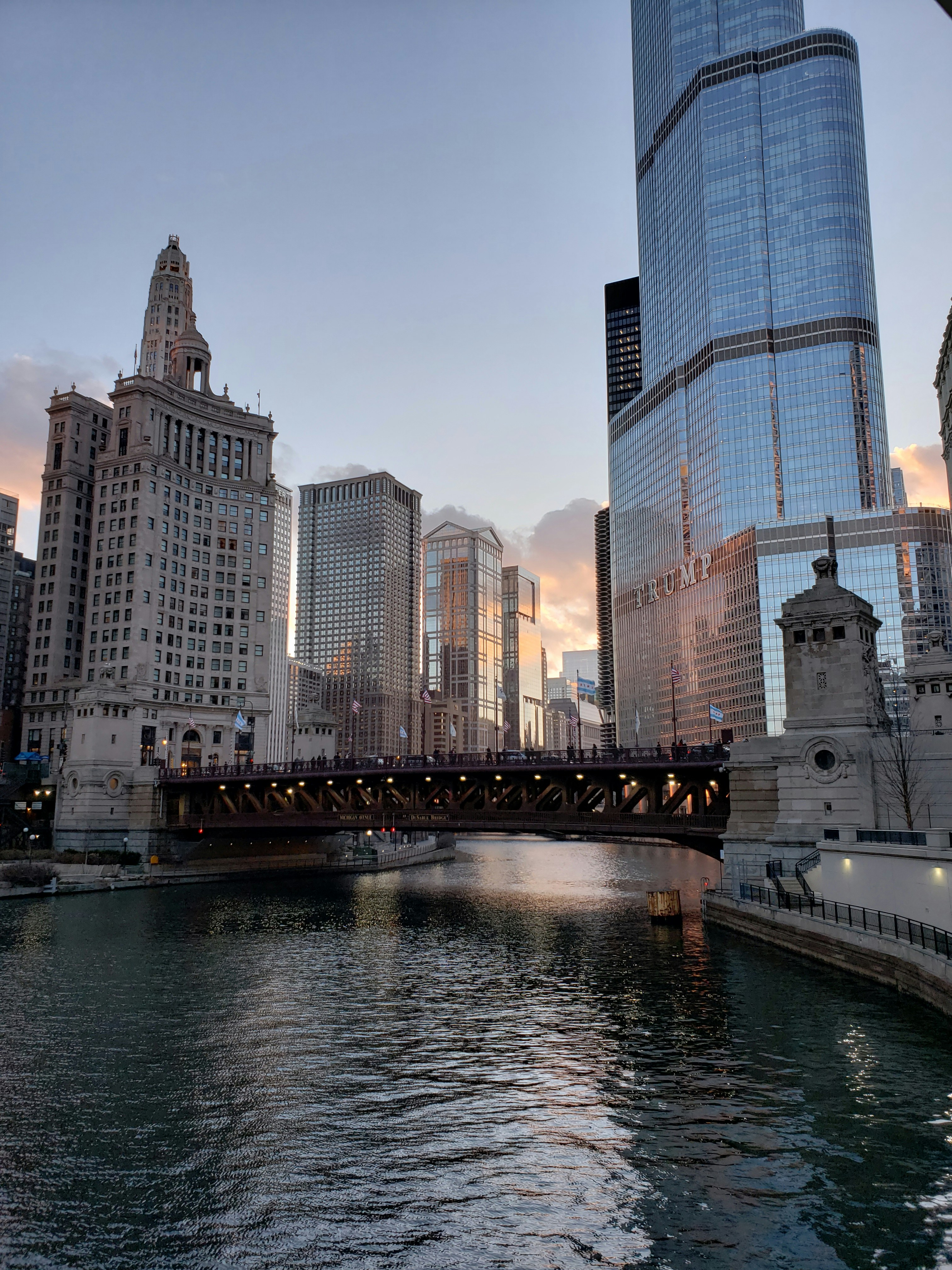 Aerial view of Chicago commercial district rooftops at dusk, dark moody sky, deep shadows, atmospheric low-light industrial setting